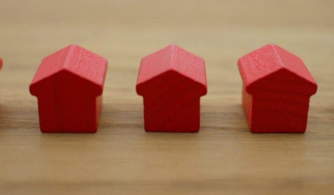 A guide to bank statements widget | Small red wooden toy houses on a wooden table