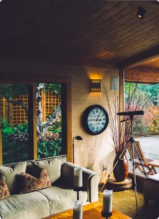 Buildings and Contents Insurance | A summer house with lots of contents including a telescope, sofa, candles and a wall clock