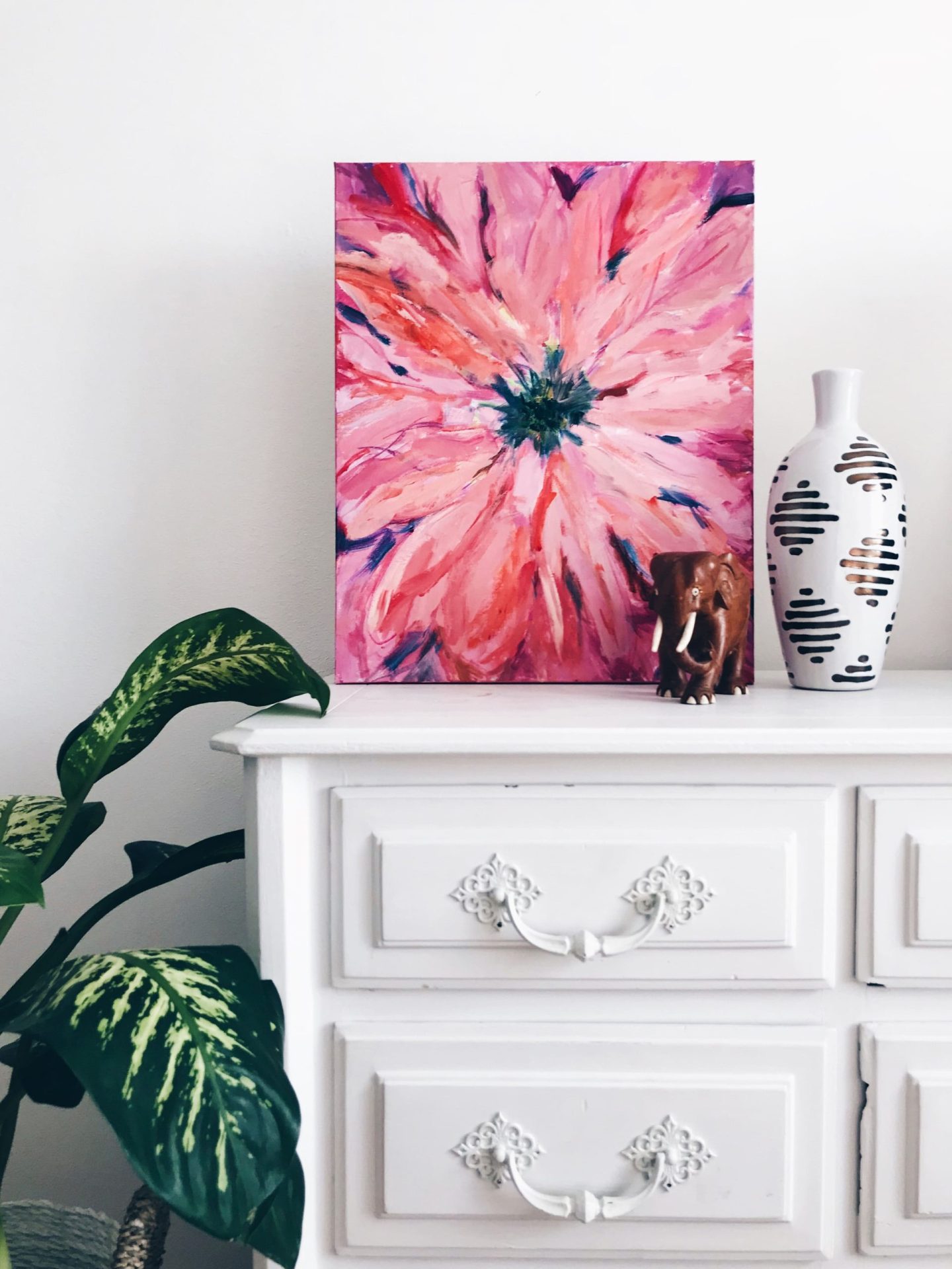 Buy-to-Let Remortgage | A white chest of draws with a vibrant pink canvas and other ornaments on top and a plant to the left hand side