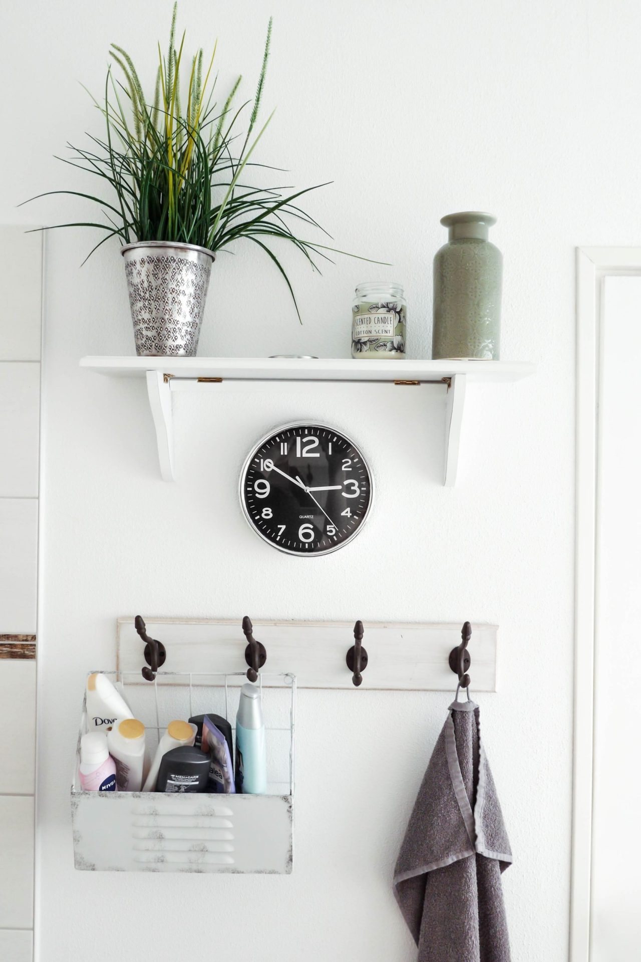 Limited Company Buy-to-Let Mortgages | Image of a bathroom wall with a shelf above a clock and then hanging pegs below