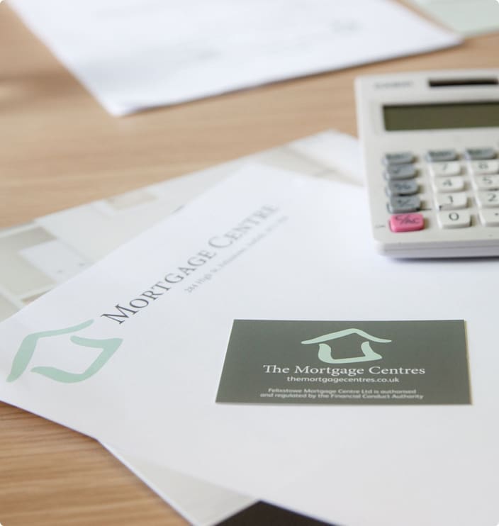 Mortgage Brokers in the UK | The Mortgage Centres business cards on top of letter headed paper and a calculator to the right hand side