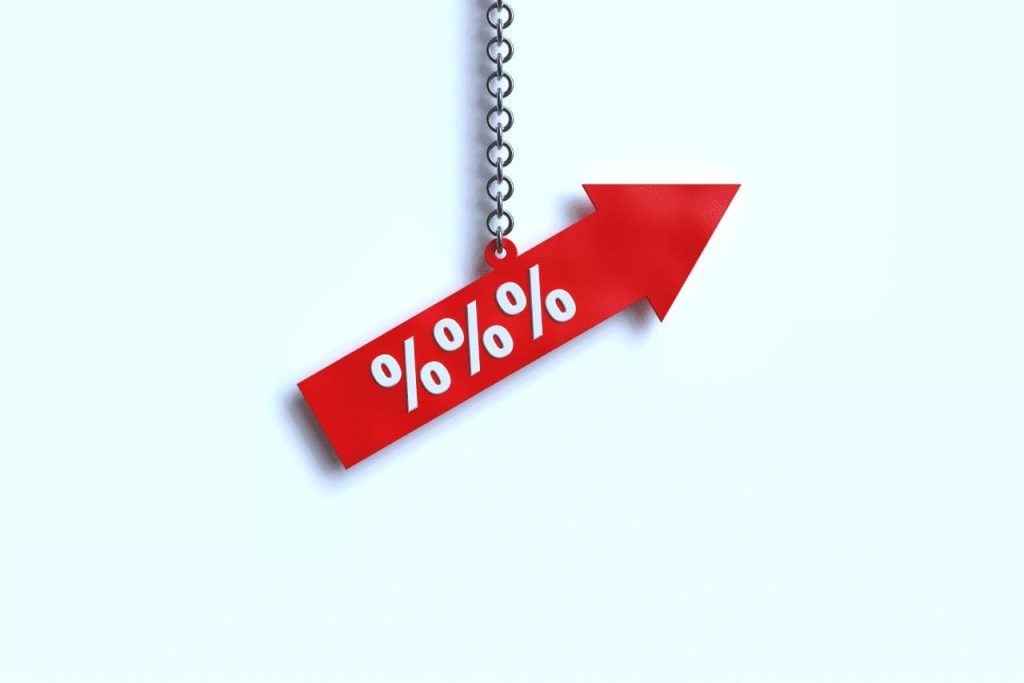 Mortgage Rate Inflation | Graphic of a red arrow with 3 percent symbols on, held up my a chain on a white background