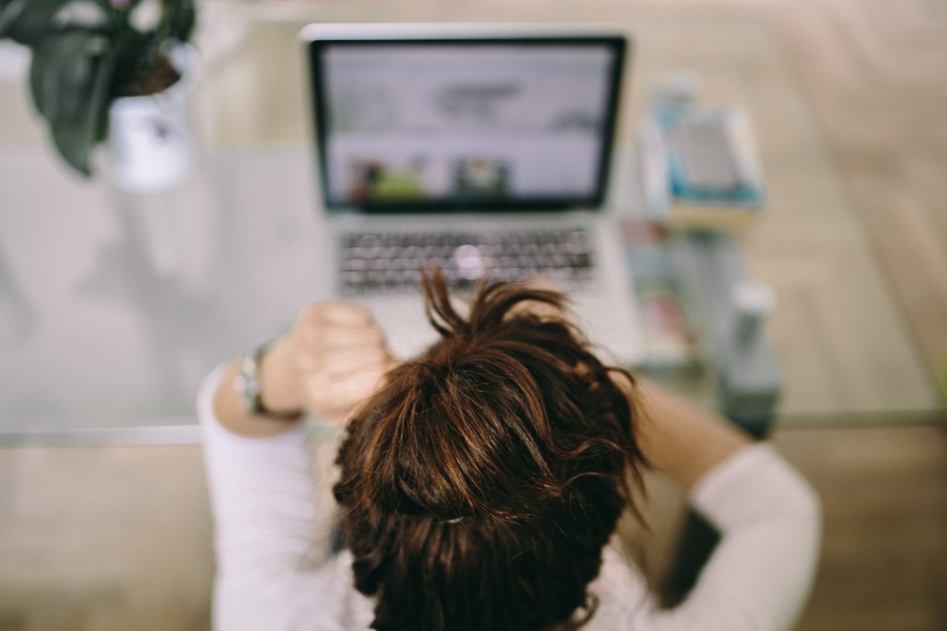 Mortgages for Company Directors | A shot of a person using a laptop from behind