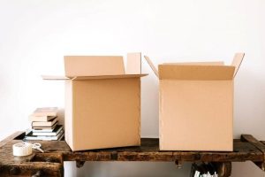 Packing Boxes on a wooden bench with scissors and cellotape