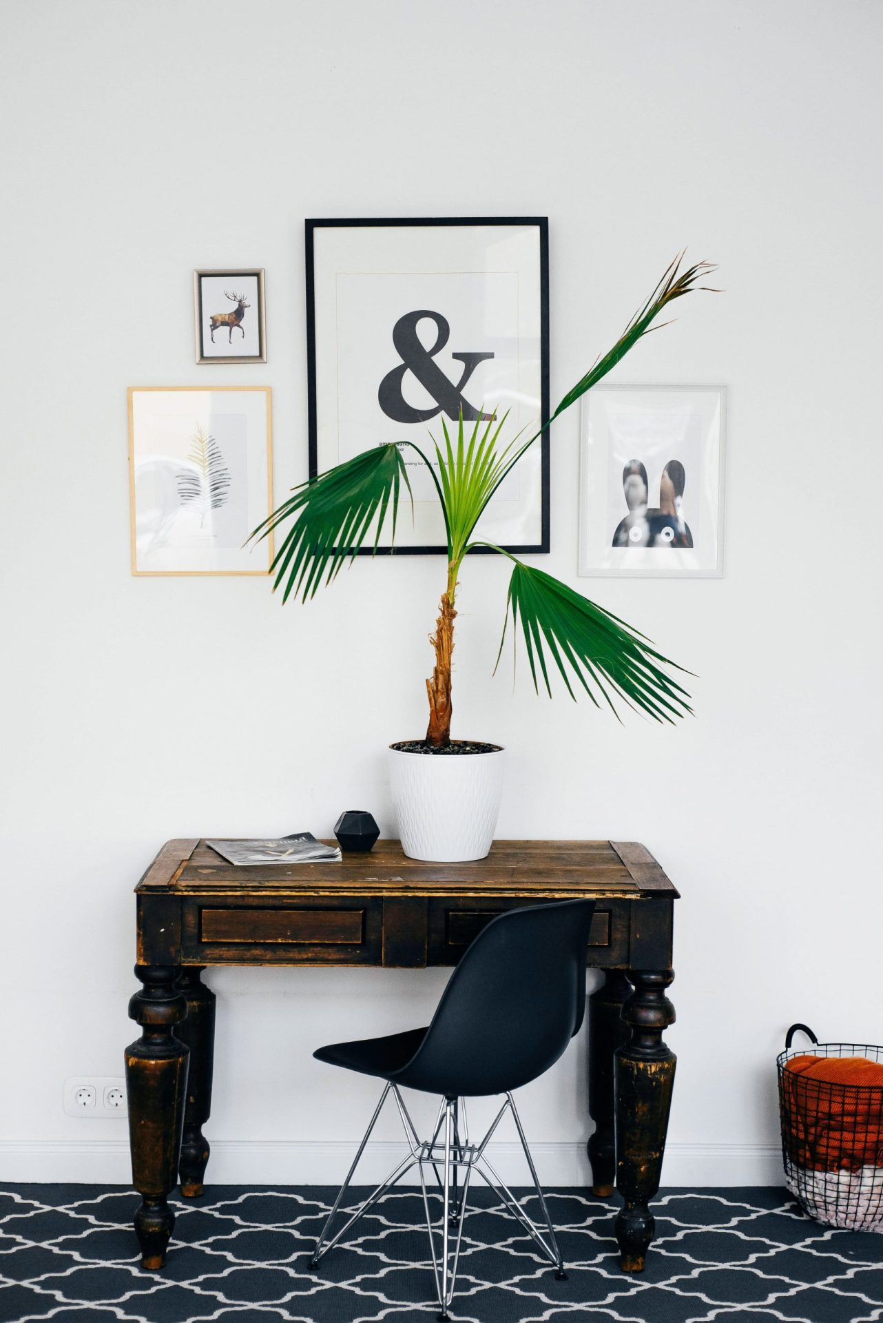 Remortgage to buy another property | Old wooden desk and chair with a plant and magazine on the desk and artwork on the wall