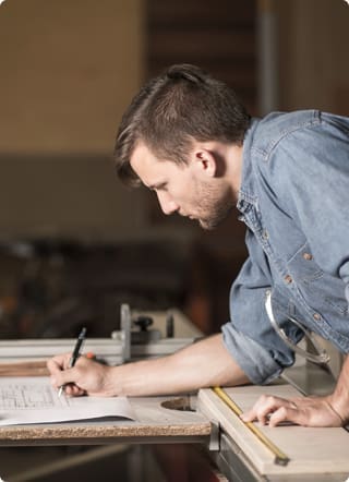 Self-Employed Mortgages Widget | Carpenter taking measurements with a tape measure