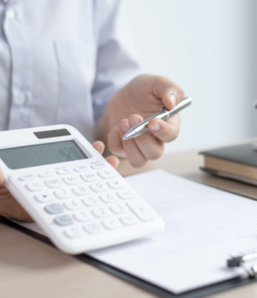 a person holding a calculator and pen